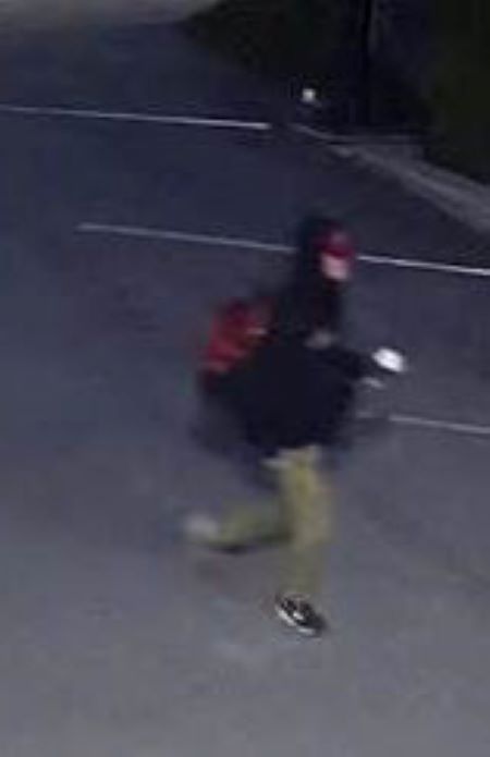  An image of the suspect walking through the parking lot before the fire.