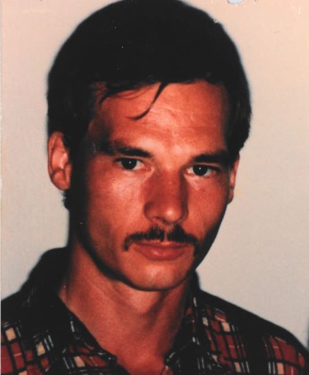Raymond Haines with dark hair and a mustache.