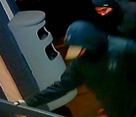 Suspects: the upper body of two suspects with masks, and dark hooded jackets. 