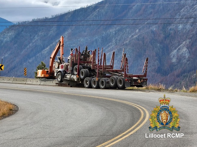 Picture of a logging truck stuck on a barricade on Hwy 12 near Lytton from file 2023-2570.