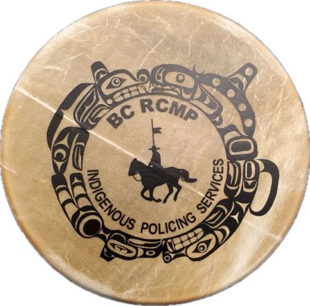 A hand drum with the BC RCMP Indigenous Policing Services logo. 